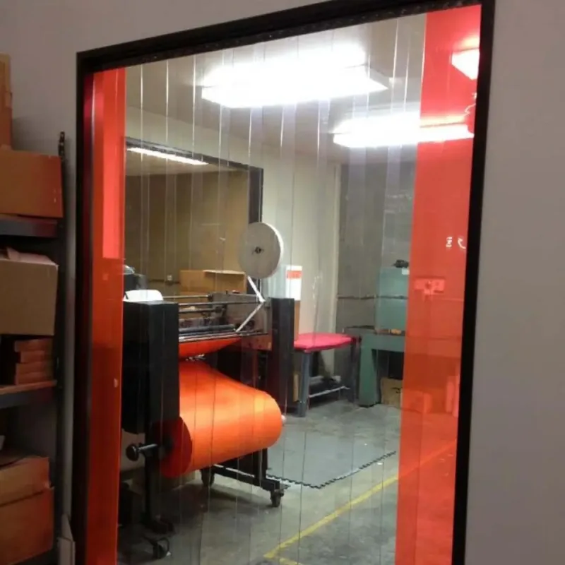 Plastic PVC strip curtains with the red end strips in a warehouse doorway