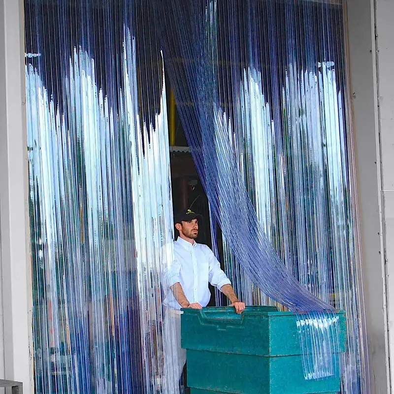 Ribbed PVC strip curtain in a doorway with a man walking through