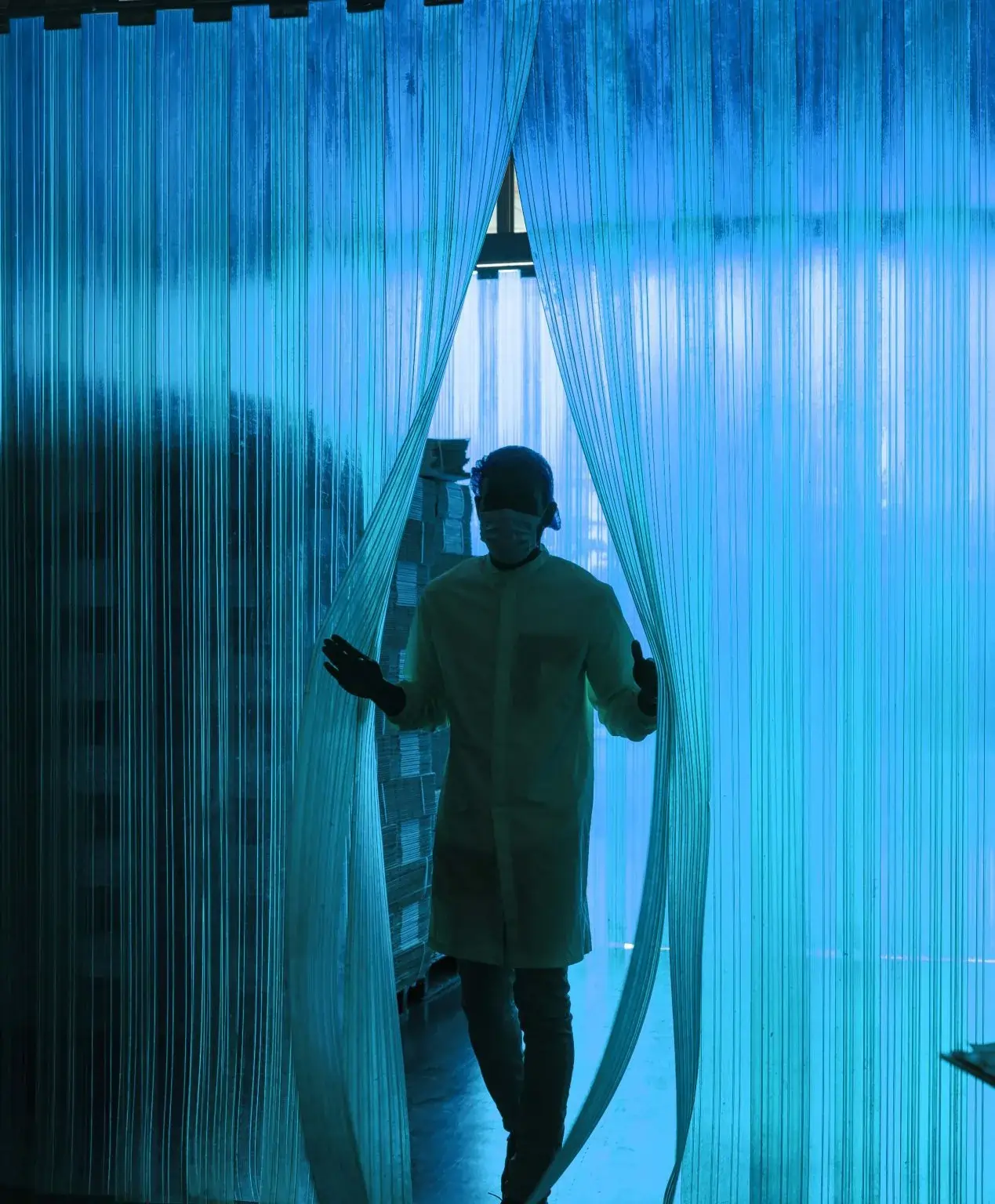 ribbed PVC strip curtains with person with a medical mask walking through