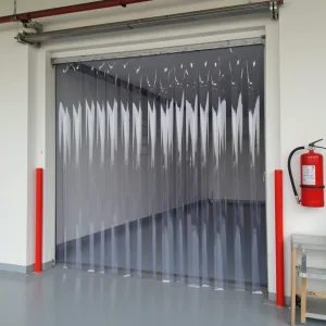 Fire retardant PVC strip curtains in a factory doorway with health and safety equipment next to the door