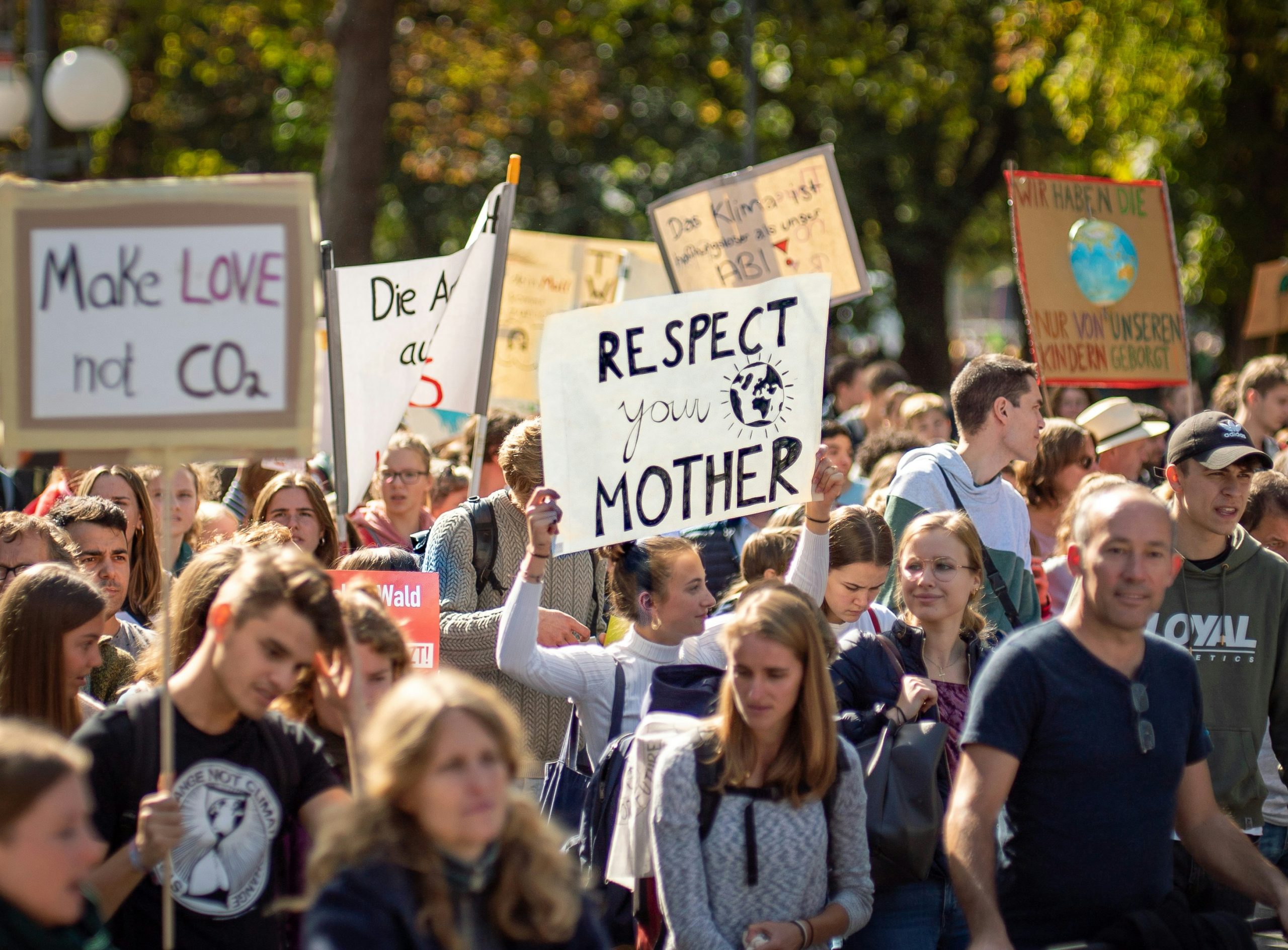 people protesting to reduce the environmental impact that companies cause